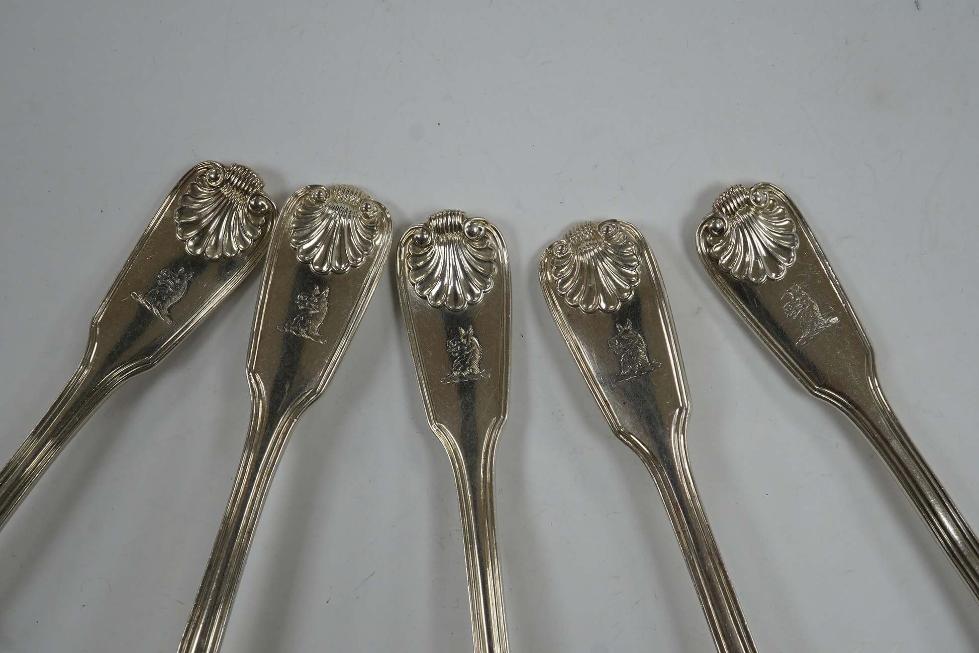 A set of six George IV silver fiddle, thread and shell pattern dessert forks and six matching spoons, William Chawner, London, 1827, 22.4oz. Condition - poor to fair
